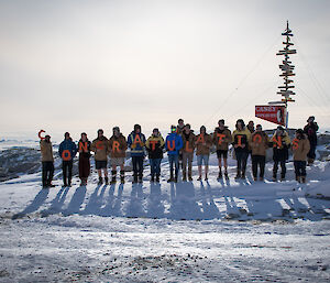 Expeditioners holding up letters to spell CONGRATULATIONS - one way to send a message if you cant be there!