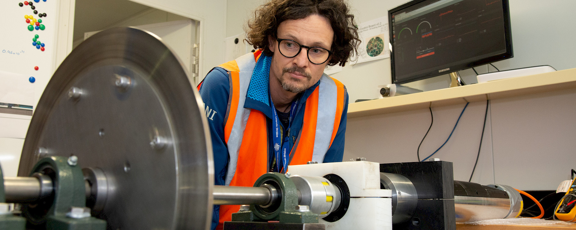 An engineer looks at the ice core drill rig.