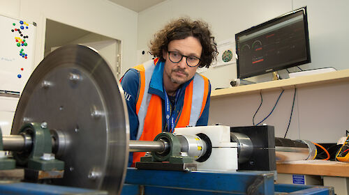 An engineer looks at the ice core drill rig.