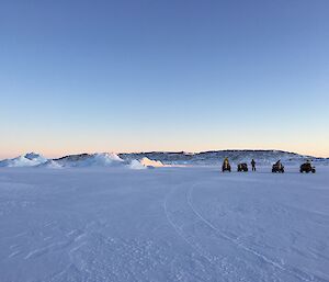 Three expeditioners on the sea ice out to drill the sea ice thickness