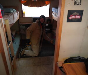 James Douglas fitting carpet squares to Robbos hut near Casey