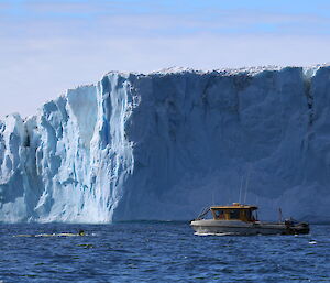 The AUV in the water at the front of the Sorsdal Glacier with a small support vessel behind it.