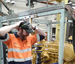 A plumber puts his hands on his head during power-house works