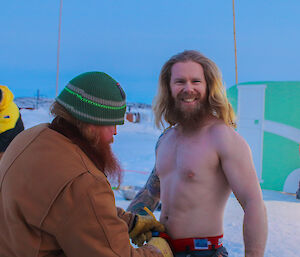 Davis station plumber, Tom Clarke, has a safety rope attached to his harness as he prepares for his icy midwinter swim.