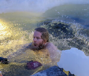 Davis station plumber, Ton Clarke, beats a hasty retreat after his midwinter swim in a hole cut in the sea ice.