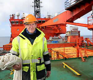 Man in hi-vis on deck of icebreaker