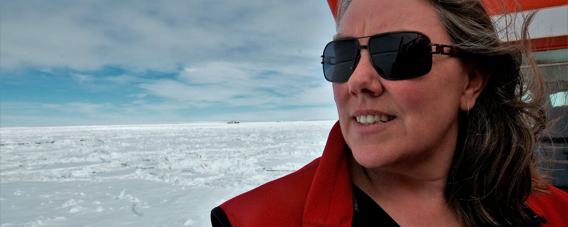 woman on bridge of icebreaker surrounded by sea ice