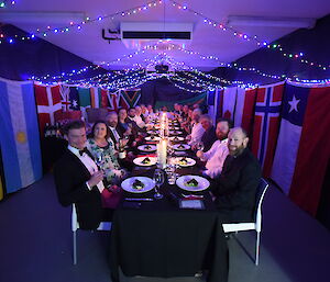 Group photo of everyone sitting at a long table wearing formal clothes
