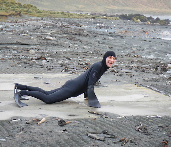 An expeditioner dressed up a seal lying on the beach