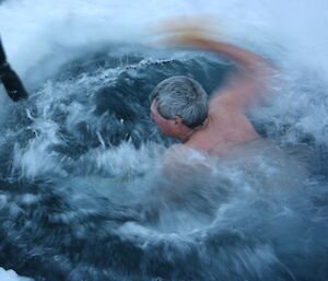 Man doing the laps in the Casey sea ice swimming pool.