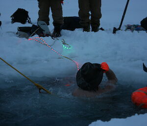 Man takes an icy dip in the Casey Midwinter pool.