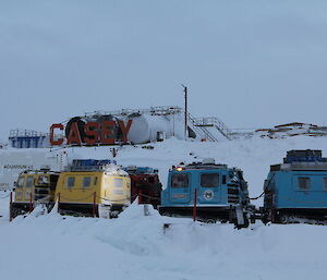 Hägglunds tracked vehicles at the station wharf, ready to provide transport back to station for Midwinter swimmers.