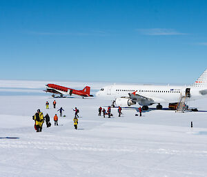 planes on ice runway with passengers getting off