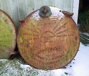 water tank lids in the snow against the field hut wall