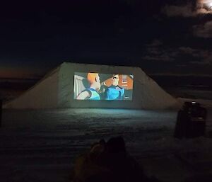 The outdoor screen with movie playing at Casey