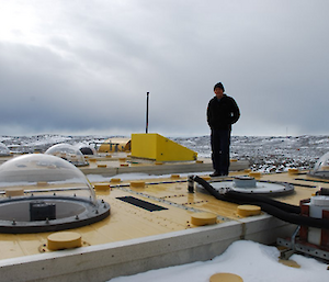 Dr John French stands on the roof of the atmospheric and space physics lab at Davis research station.