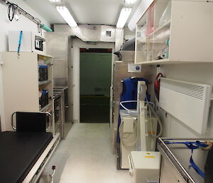 Looking towards the stainless steel scrub area to the left of the door and to the right, bolted to the floor, is the X-ray machine.