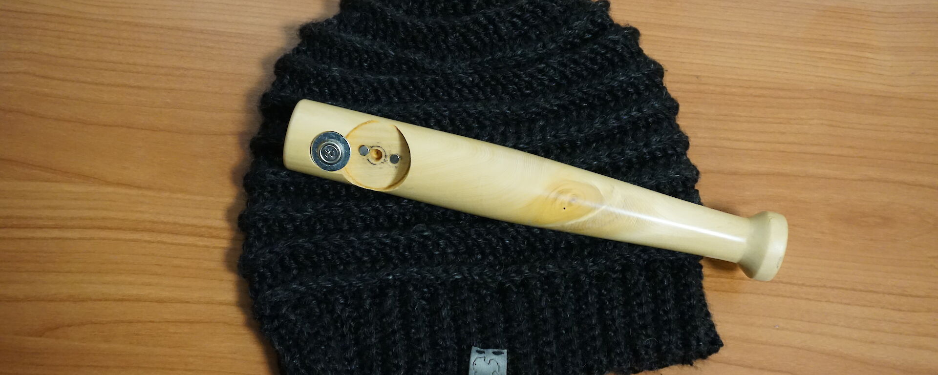 A locally knitted beanie and bottle opener made for an expeditioners birthday at Casey