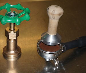 Two coffee tampers made from scrap materials on station