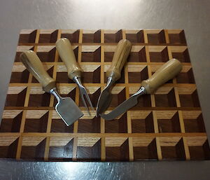 A 3D cheeseboard with fancy cheese knives made by an expeditioner