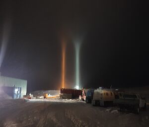 Pillars of light caused by diamond dust ice particles in the air reflecting the lights of the workshop
