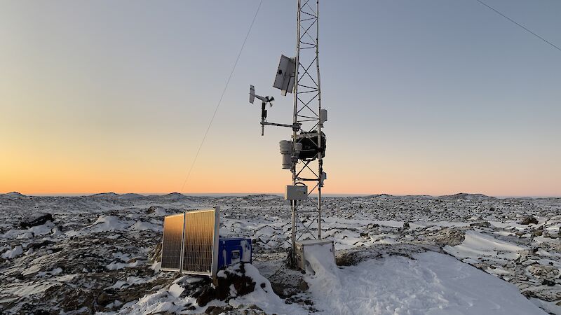 A piece of technical equipment with a orange sky in the background