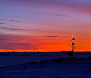 Deep reds of an early sunrise behind the Casey sign