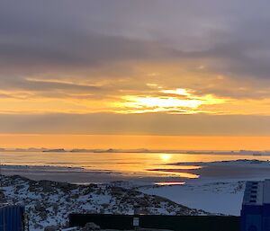 The sun is high in the sky and reflecting off the Antarctic waters of the polynya near station