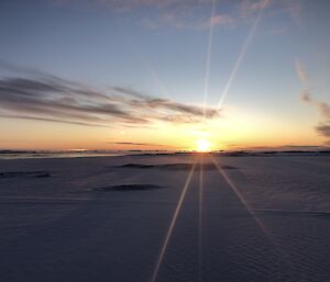 A view across the sea ice in Newcomb Bay during June with the sun just rising at midday