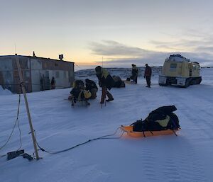 A man-hauling team (men pulling sleds) arriving at the Wilkes Hilton on the Clark Peninsula