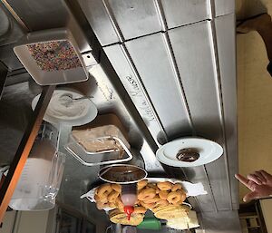 Donuts and toppings on the kitchen work bench