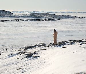 An expeditioner looking out over the sea ice from Shirley Island near Casey