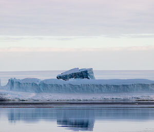 Long rectangular iceberg in the water