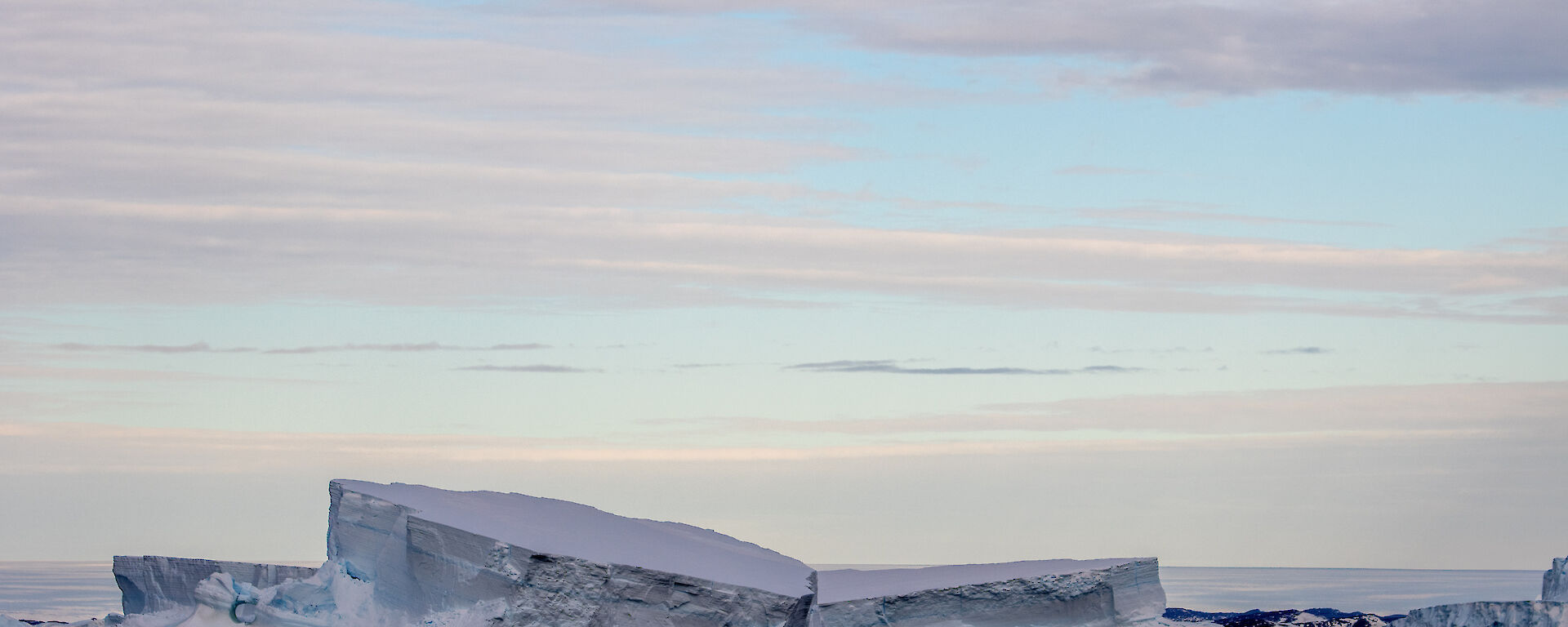 Icebergs being reflected in the water on a still day