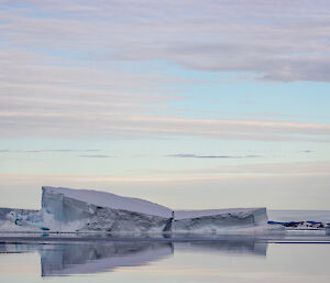 Icebergs being reflected in the water on a still day