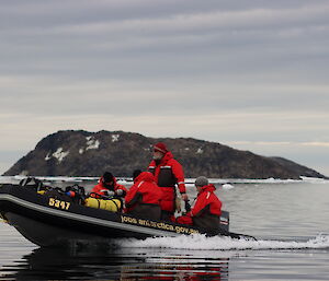 A group of expeditioners in an inflatable rubber boat cruising in the water