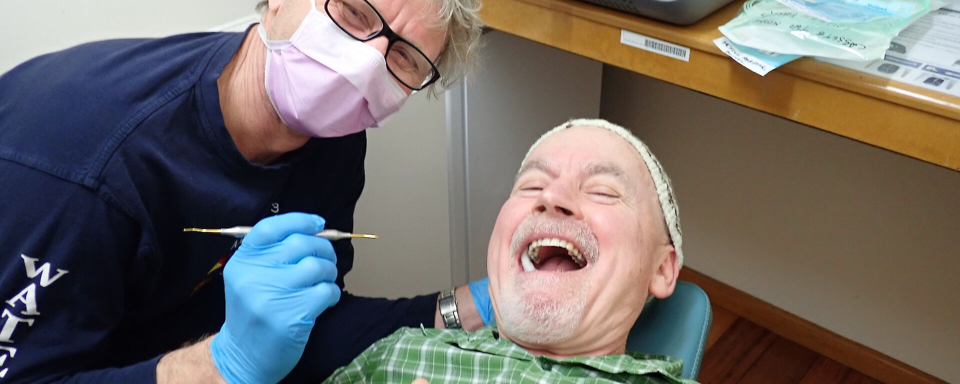 Doctor gives the thumbs up while lying down in the dental suite