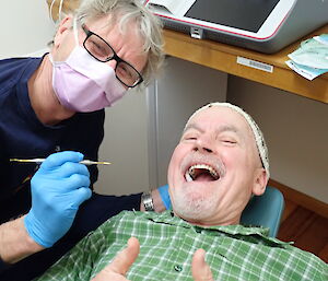 Doctor gives the thumbs up while lying down in the dental suite