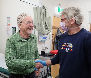 Two expeditioners wearing gloves and mask in the dental suite