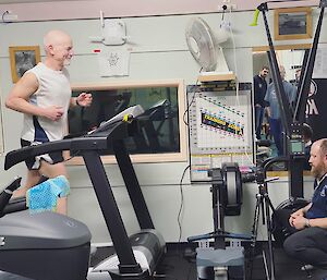 Station doctor is getting filmed while running on a treadmill