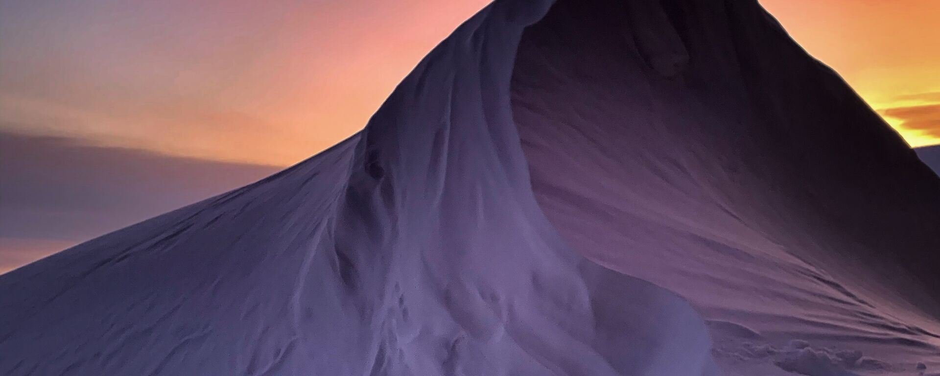 Neon Sky and snow drift on a snowy mountain