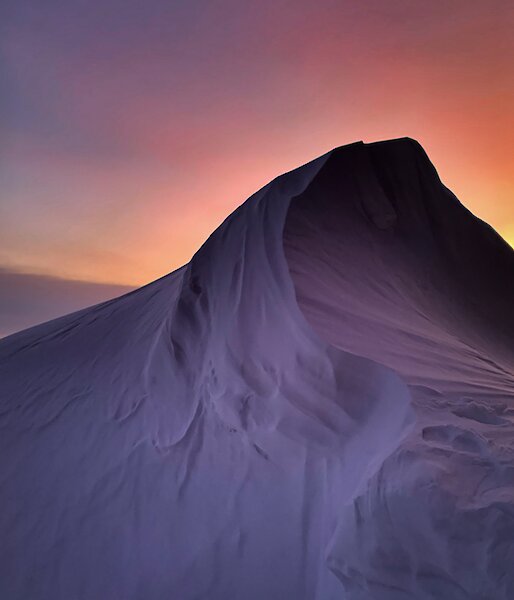 Neon Sky and snow drift on a snowy mountain