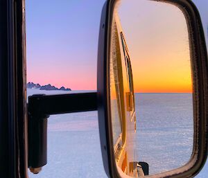 Reflection of the sky from a vehicle's side mirror