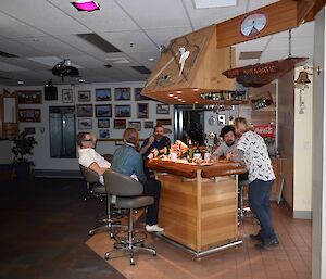 A group gathered around the bar