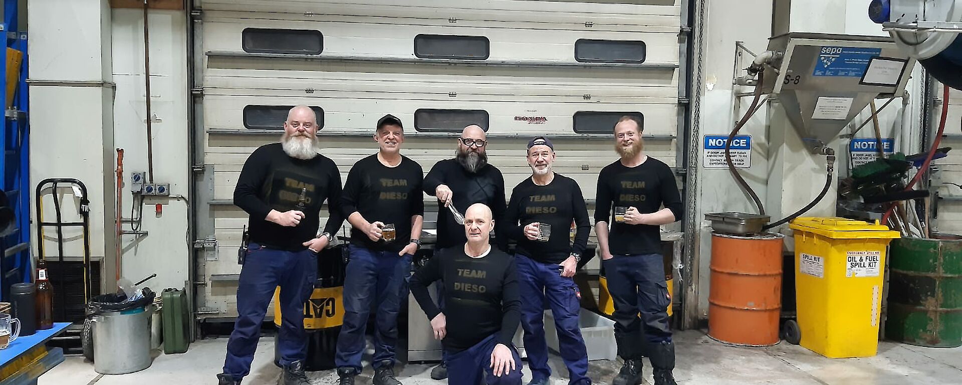 A group of expeditioners standing in the workshop