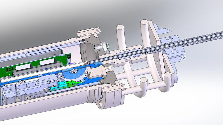 A model graphic showing the electrical-optical-mechanical cable running through a penetrator into the end cap and terminating in a titanium pressure housing.