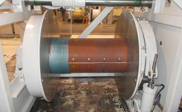 An electrical-optical-mechanical cable being spooled onto a winch drum.