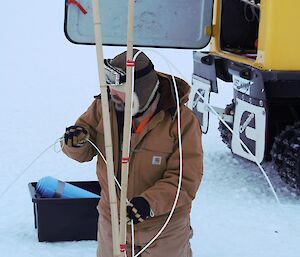 An expeditioner deploying the mass balance thermistor measurement