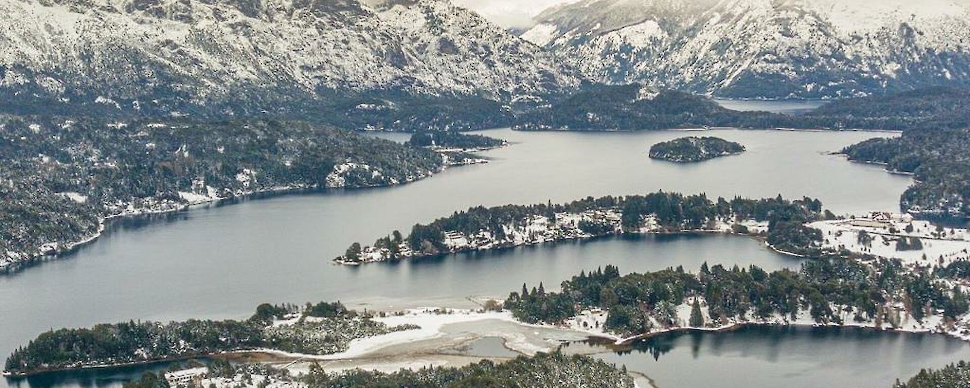 Vista of snow covered mountains and lake in Argentina