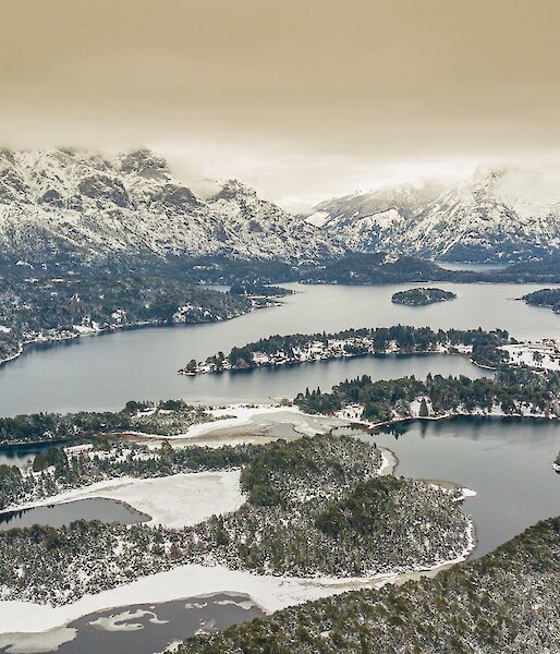Vista of snow covered mountains and lake in Argentina